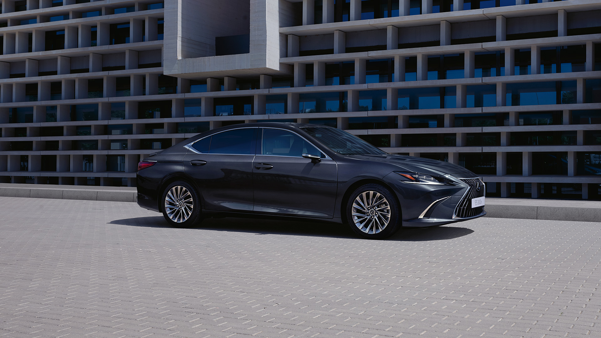 Side view of a Lexus ES parked outside a building 