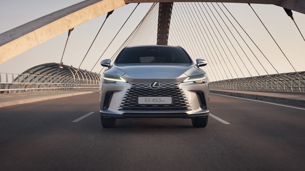 A Lexus UX 300e and Lexus NX plugged into a charging tower 