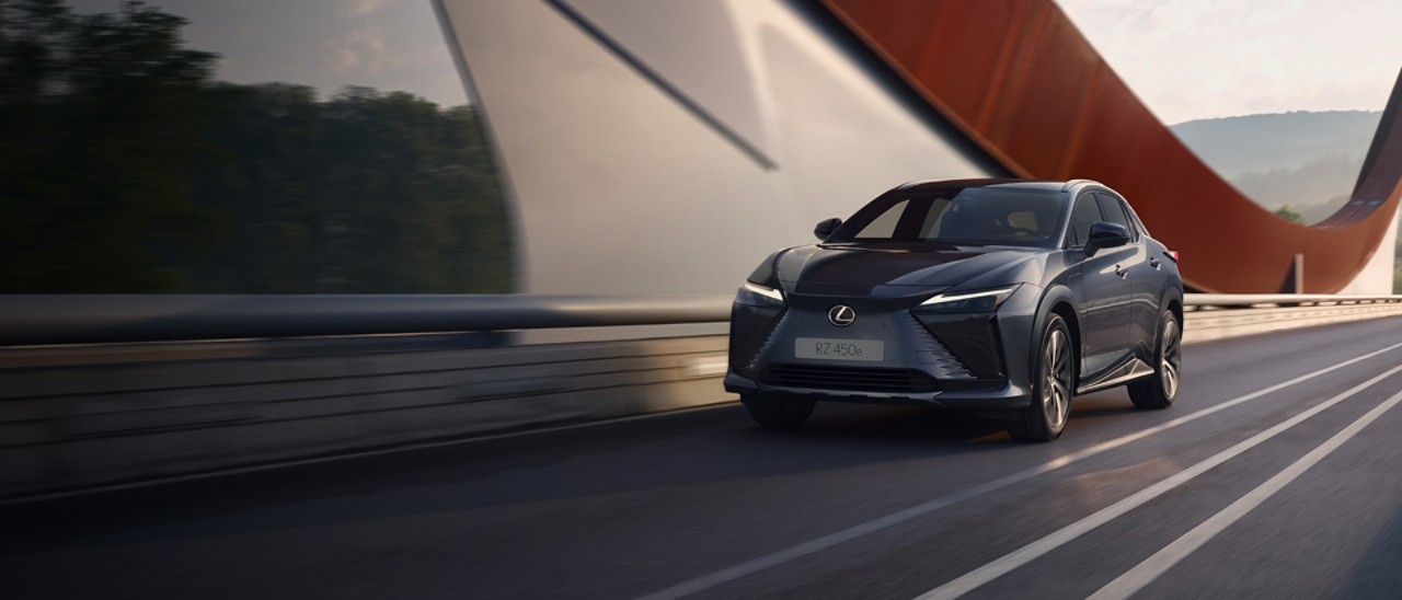 Lexus RZ 450e driving across a bridge 