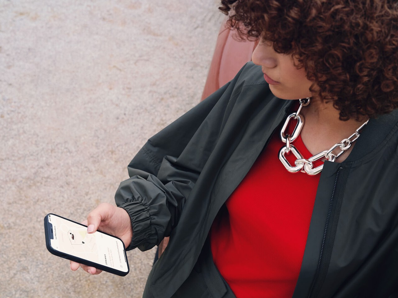 A woman using her mobile phone to access the Lexus Link app 