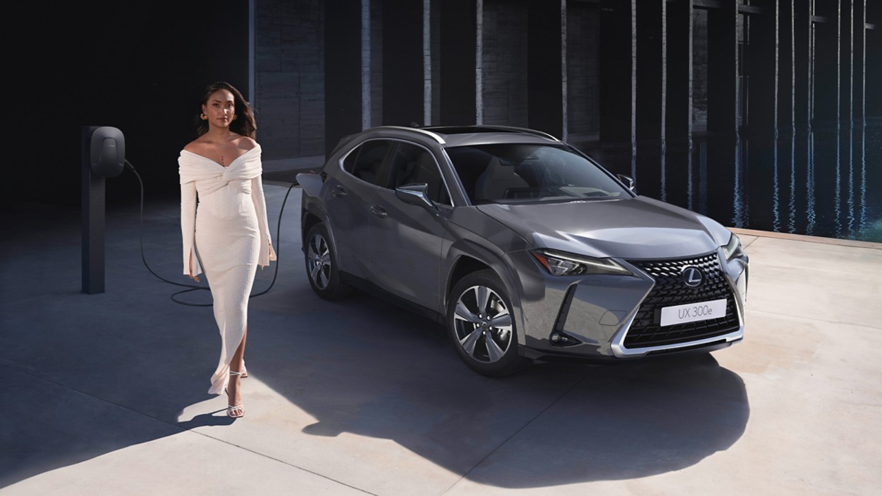 A Lexus UX 300e plugged into a charging tower