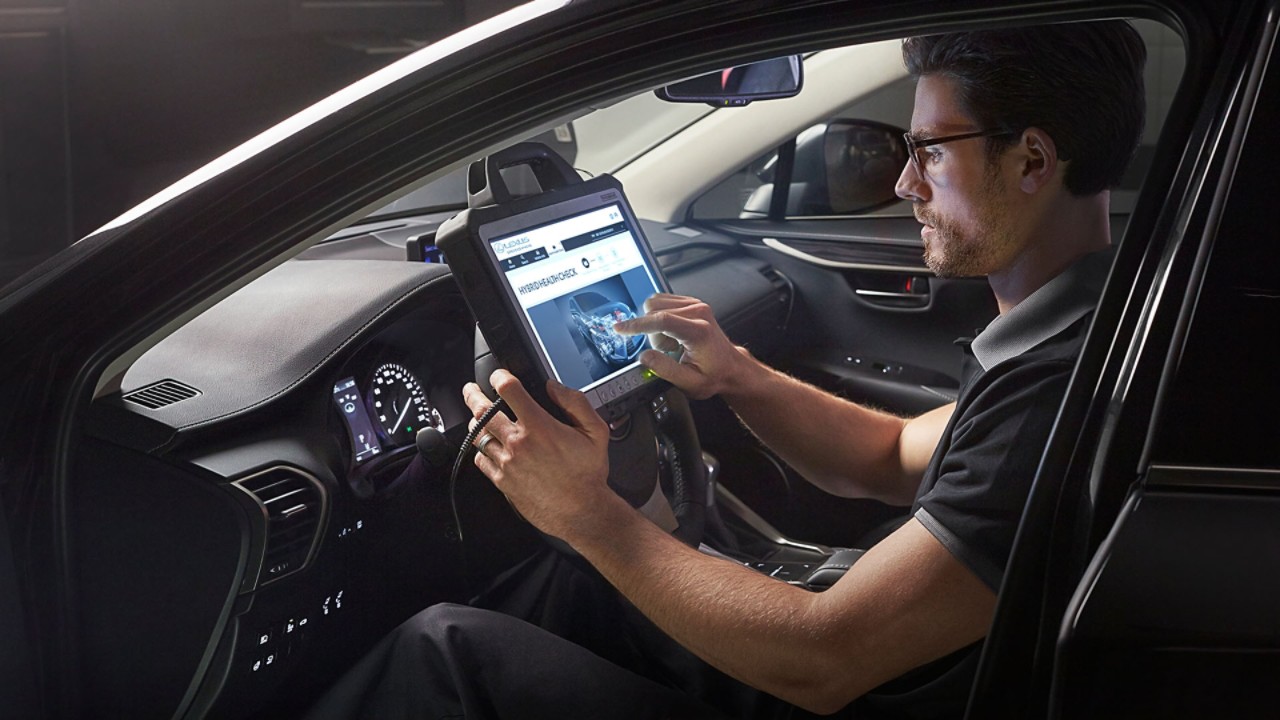A man sat in the drivers seat of a Lexus
