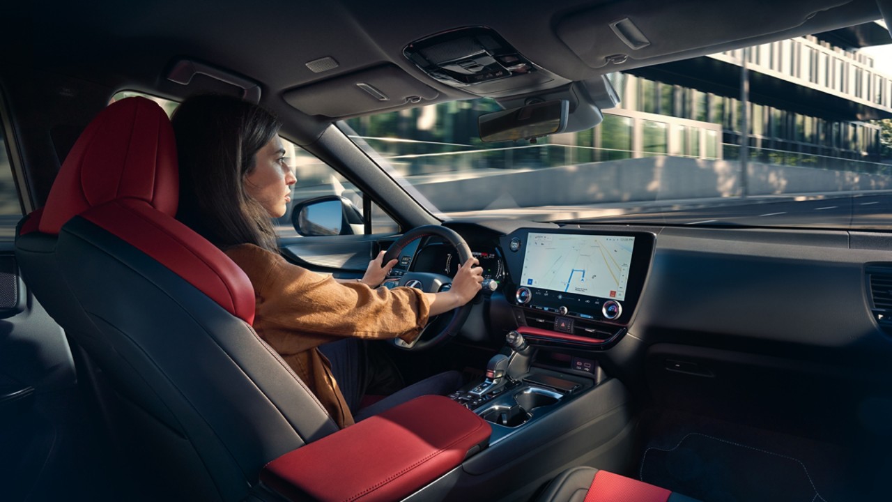 A woman driving a Lexus NX