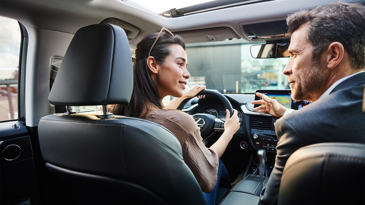 A man and woman sat in a Lexus
